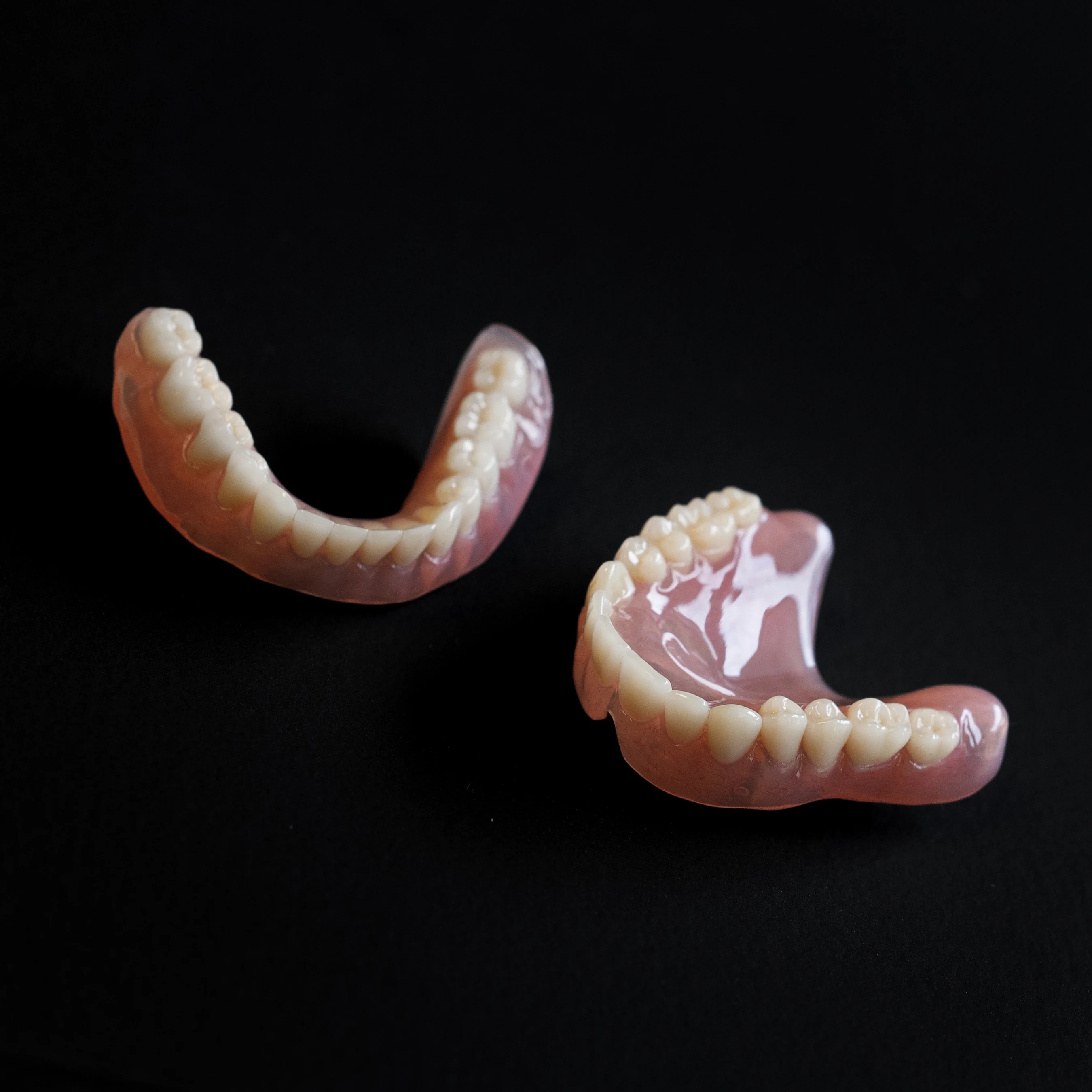 Removable dentures on a black background